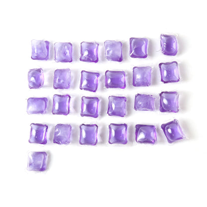 Wukusy laundry detergent pods in a 25-piece pack, showing white pods with blue and green accents in a clear container.
