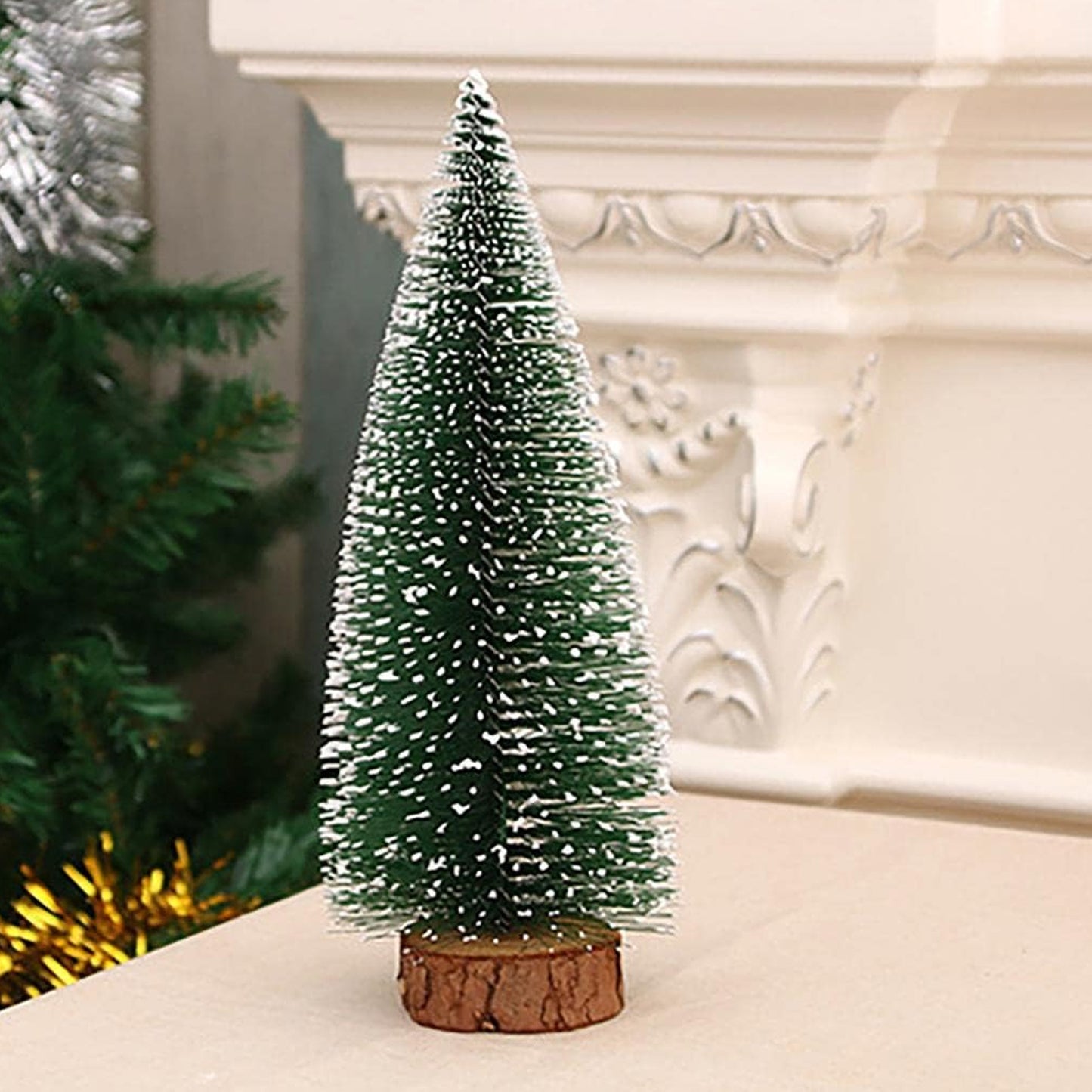 Wukusy mini artificial Christmas tree with snow effect, showcasing a small festive tree decorated with snow-like accents.