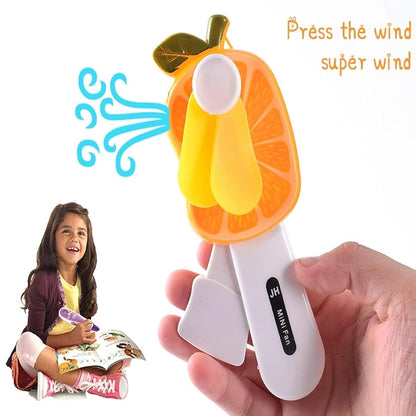 Mini hand pressure fruit-shaped fan for kids by Wukusy, colorful and portable with fun fruit designs, perfect for children.