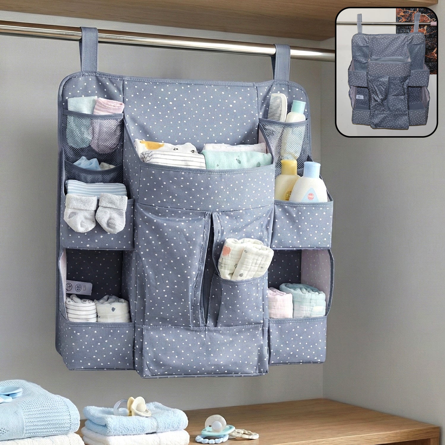Wukusy multi-pocket hanging baby care organizer with multiple compartments for baby essentials, hanging on a nursery wall.
