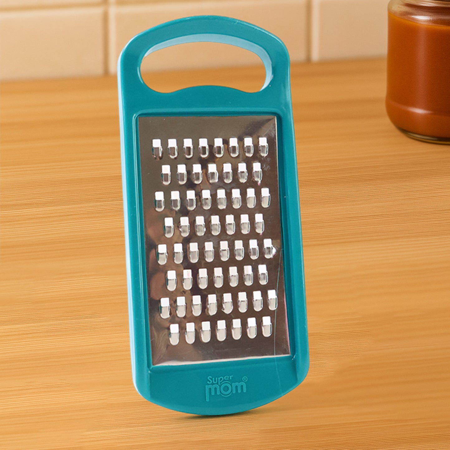 Wukusy multipurpose cheese and vegetable grater with a handle, designed for shredding cheese, vegetables, and more.