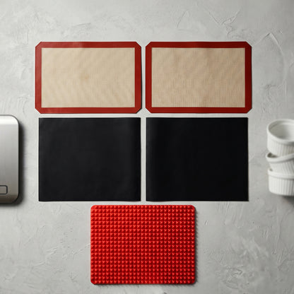 Wukusy 5-piece non-stick silicone baking mat set for versatile baking, cooking, and food prep on a flat surface.
