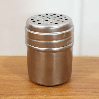 Stainless-steel Wukusy spice shaker container for storing and sprinkling spices, with a sleek, durable design.