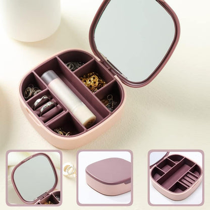 Wukusy plastic jewelry storage box with built-in mirror and multiple compartments for organized jewelry storage.