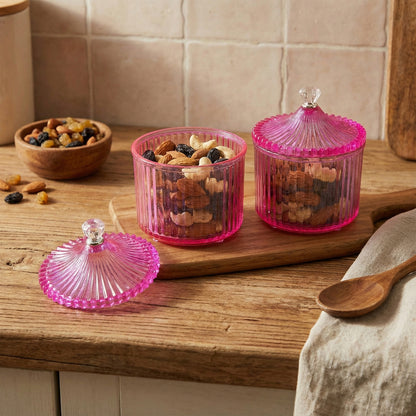 Two Wukusy plastic luxury transparent dry fruit storage jars with secure lids, ideal for organizing dried fruits.