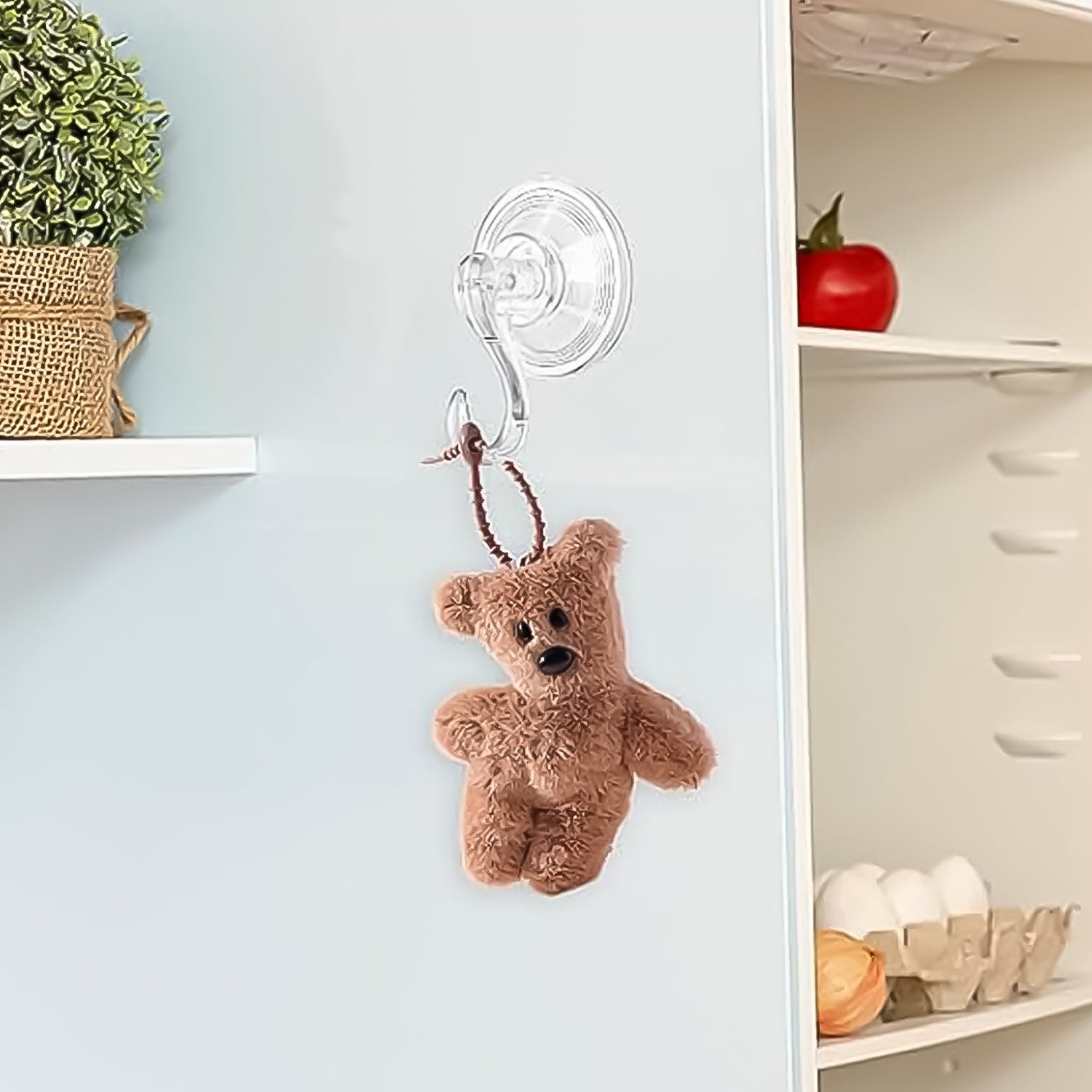 Set of four Wukusy plastic suction cup hooks attached to a bathroom wall for hanging towels and accessories.
