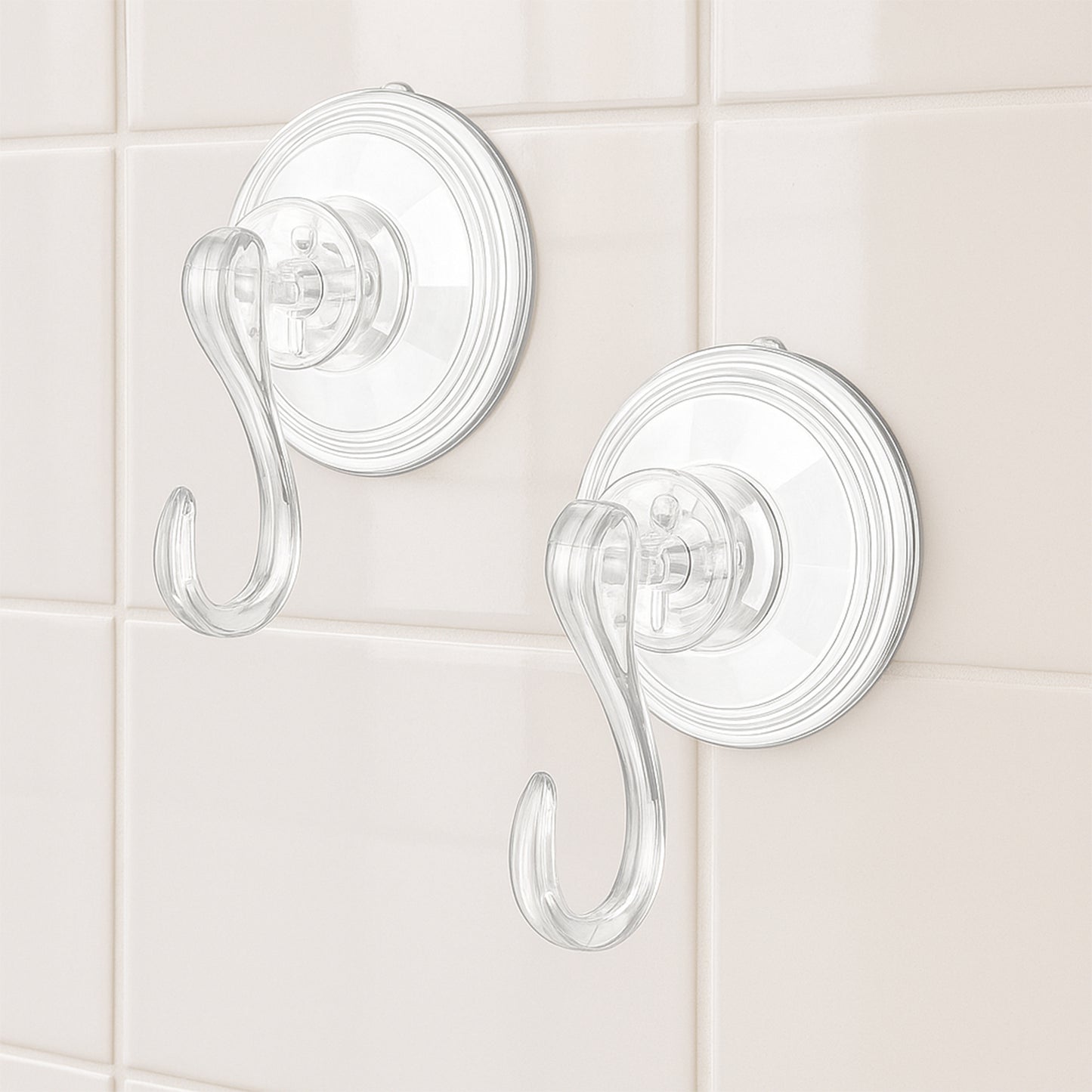 Set of four Wukusy plastic suction cup hooks attached to a smooth surface for hanging items in bathroom or kitchen.