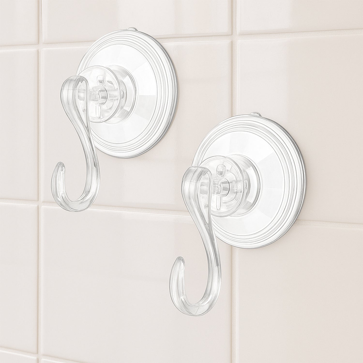 Set of four Wukusy plastic suction cup hooks attached to a smooth surface for hanging items in bathroom or kitchen.