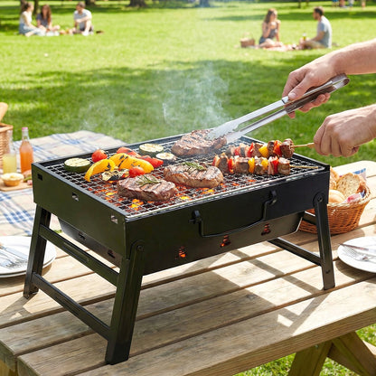 Wukusy portable foldable charcoal BBQ grill with grilling mesh, 36x27 cm, compact and lightweight for outdoor cooking.