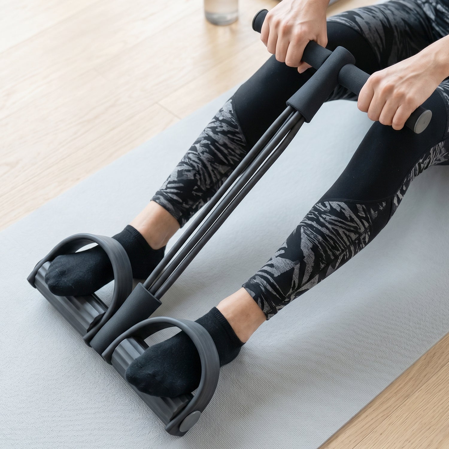 Wukusy portable pull rope resistance exerciser with foot pedal support, compact workout equipment for strength training.