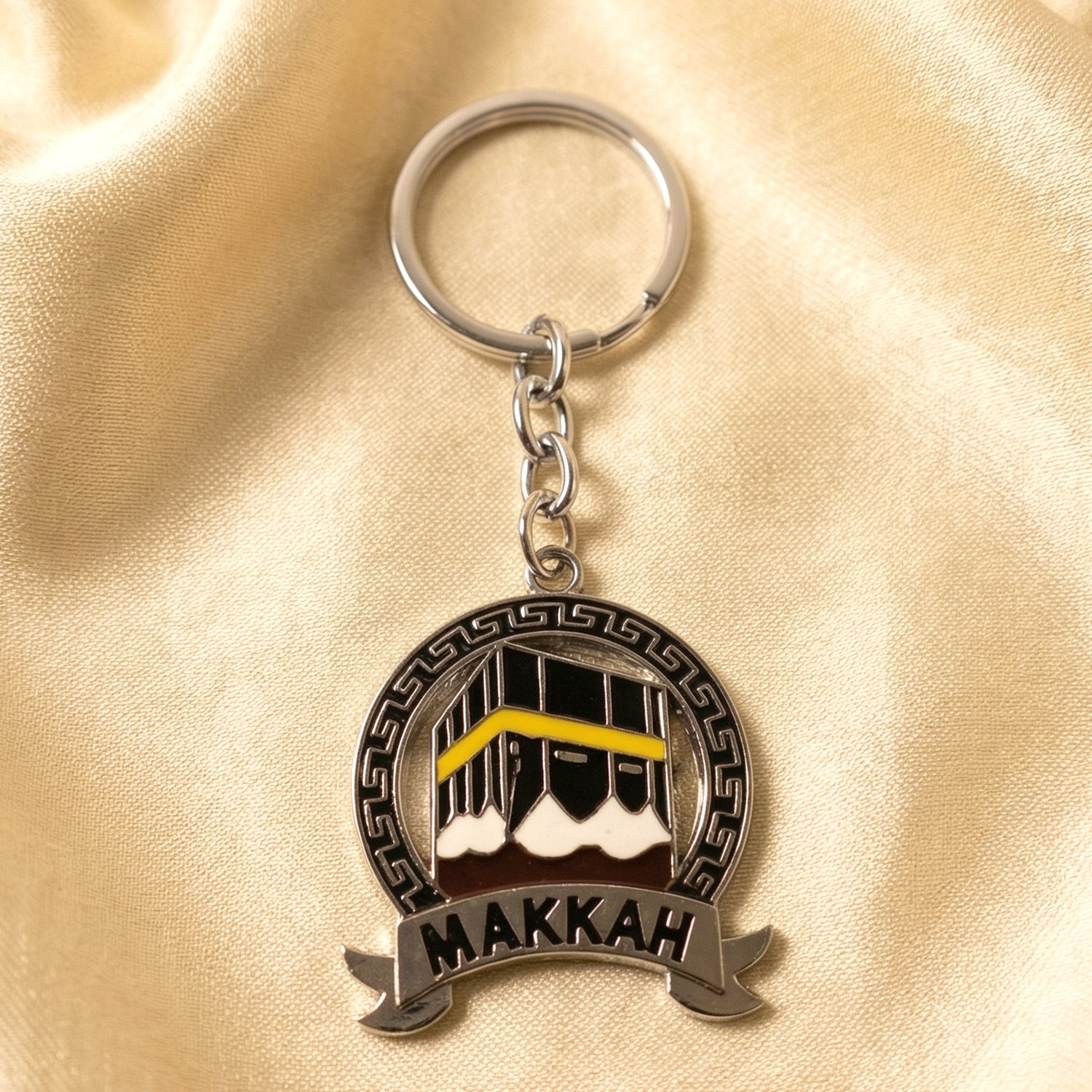 Wukusy premium Makkah design metal keychain with round pendant, featuring intricate Islamic artwork and a polished finish.