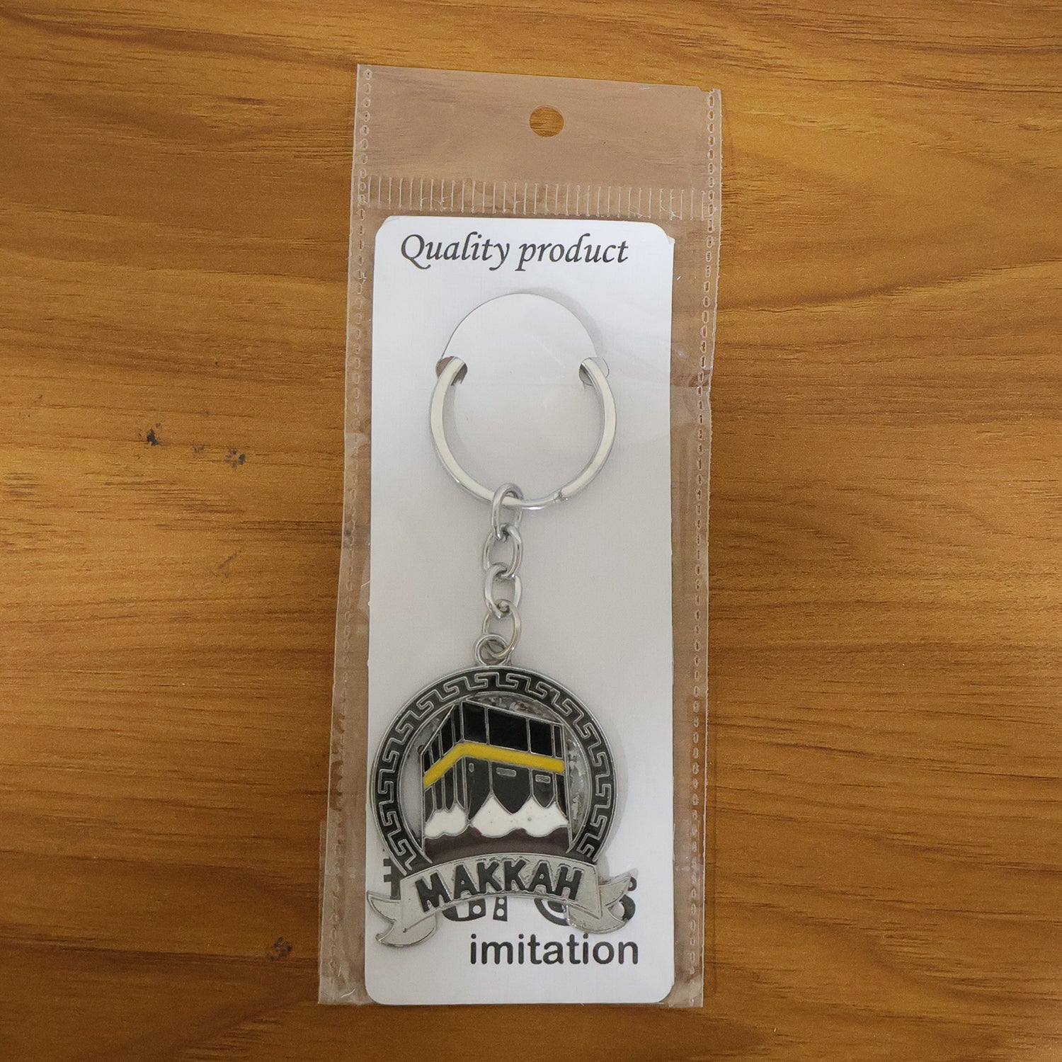 Wukusy premium Makkah design metal keychain with round pendant, showcasing intricate Islamic pattern and shiny finish.