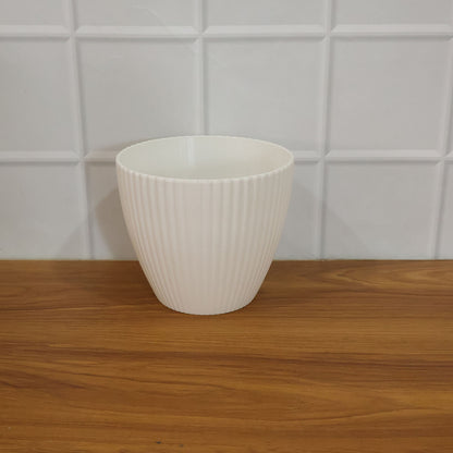 White ribbed decorative flower pot by Wukusy, premium ceramic planter with textured design for indoor or outdoor use.