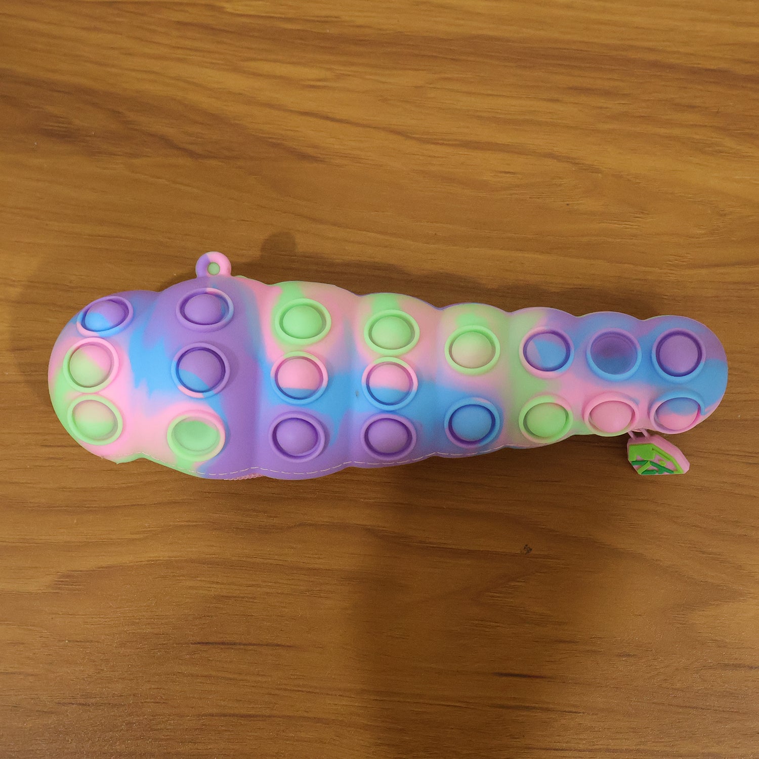 Rainbow Caterpillar Pop It Toy by Wukusy featuring colorful silicone bubbles for sensory fun and stress relief.