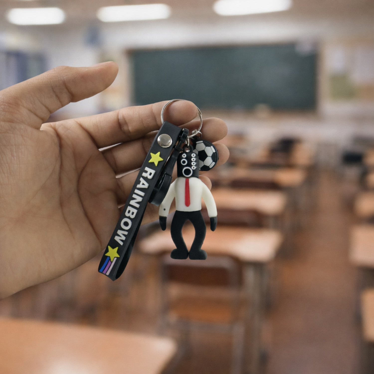 Wukusy Rainbow Strap Cartoon Football Boy Keychain showing a colorful football-themed character on a rainbow strap.