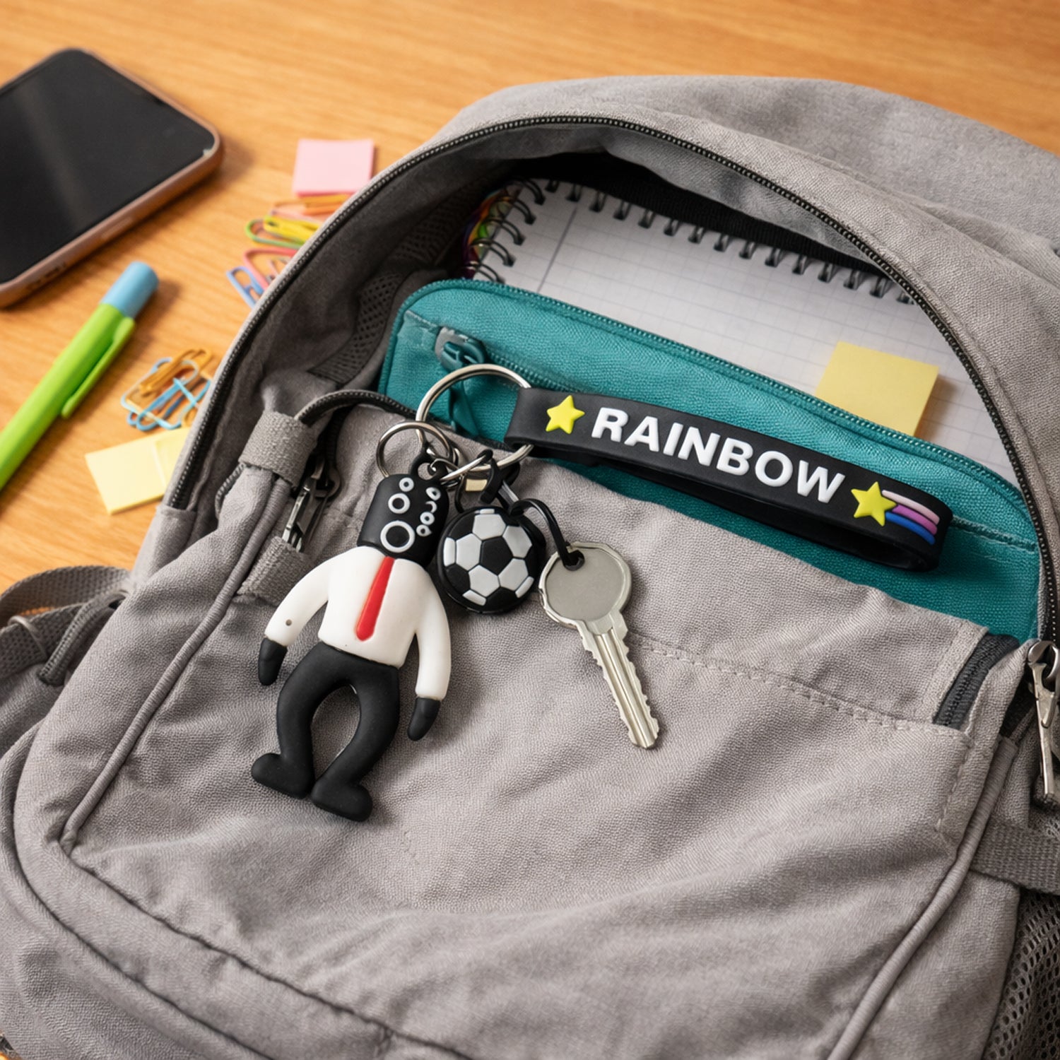 Rainbow strap cartoon football boy keychain by Wukusy, featuring a playful football-themed character on a colorful strap.