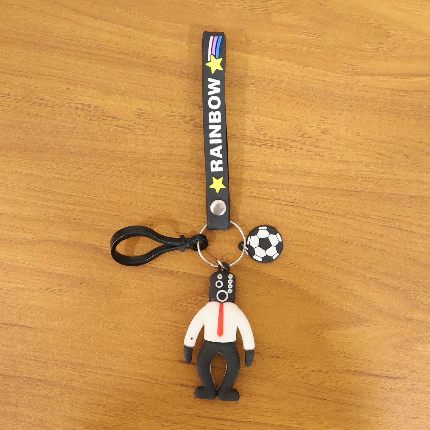 Colorful Rainbow Strap Cartoon Football Boy Keychain by Wukusy, featuring a playful football-themed character on a vibrant strap.