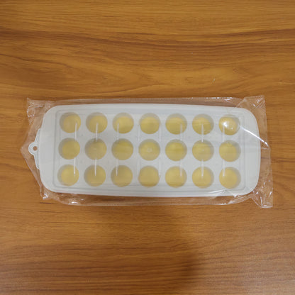 Wukusy round ball ice cube tray with lid, 21-grid ice mold tray for making spherical ice cubes in a kitchen or bar setting.