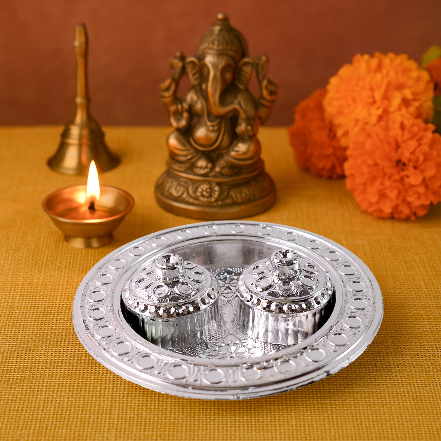 Small round Wukusy Puja Thali Kumkum holder, traditional metal plate for religious rituals and offerings.