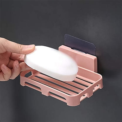 Wukusy self-adhesive rectangular soap dish holder attached to a bathroom wall, designed to keep soap dry and accessible.