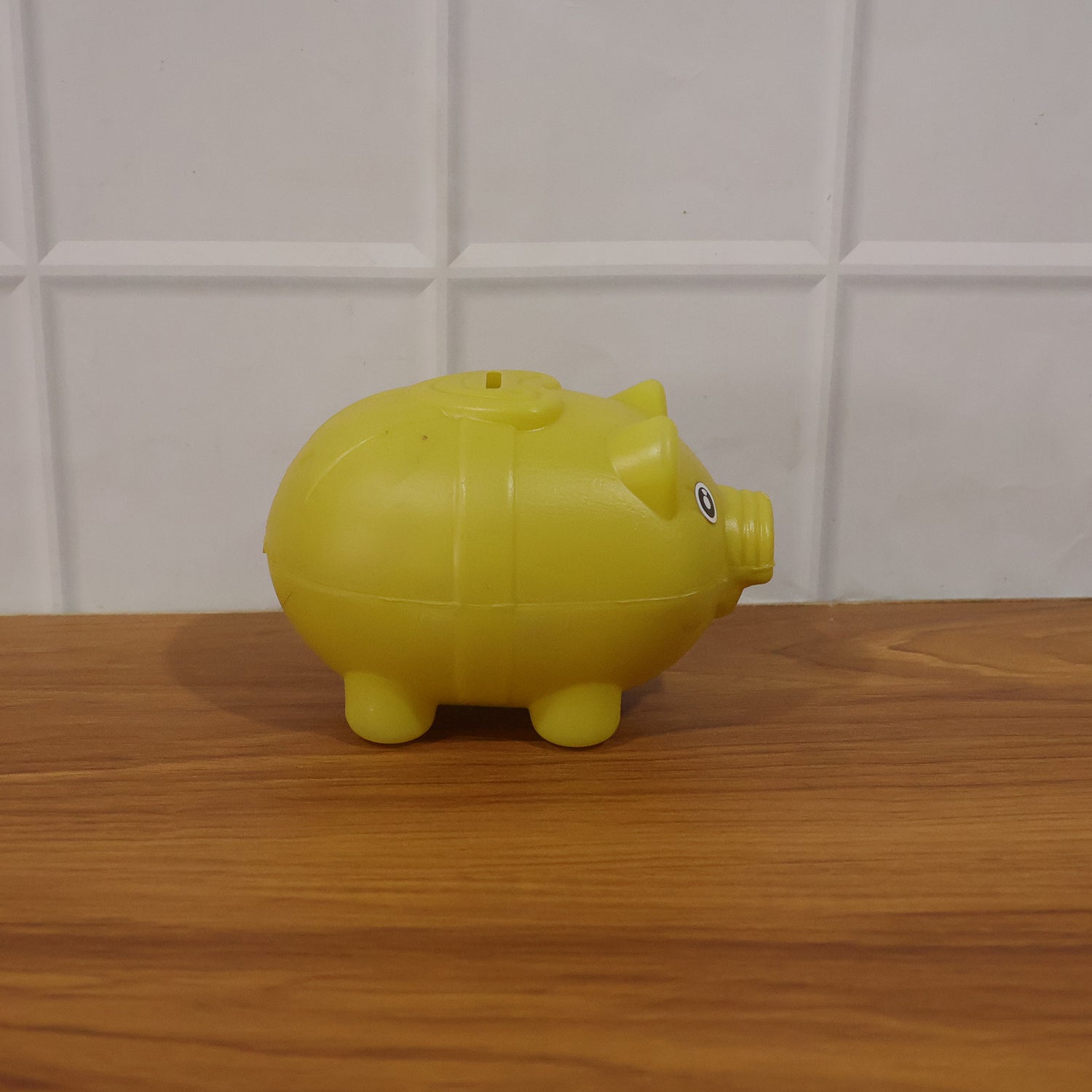 Small Wukusy piggy money bank coin saving box for kids, featuring a cute pig design and secure coin slot.
