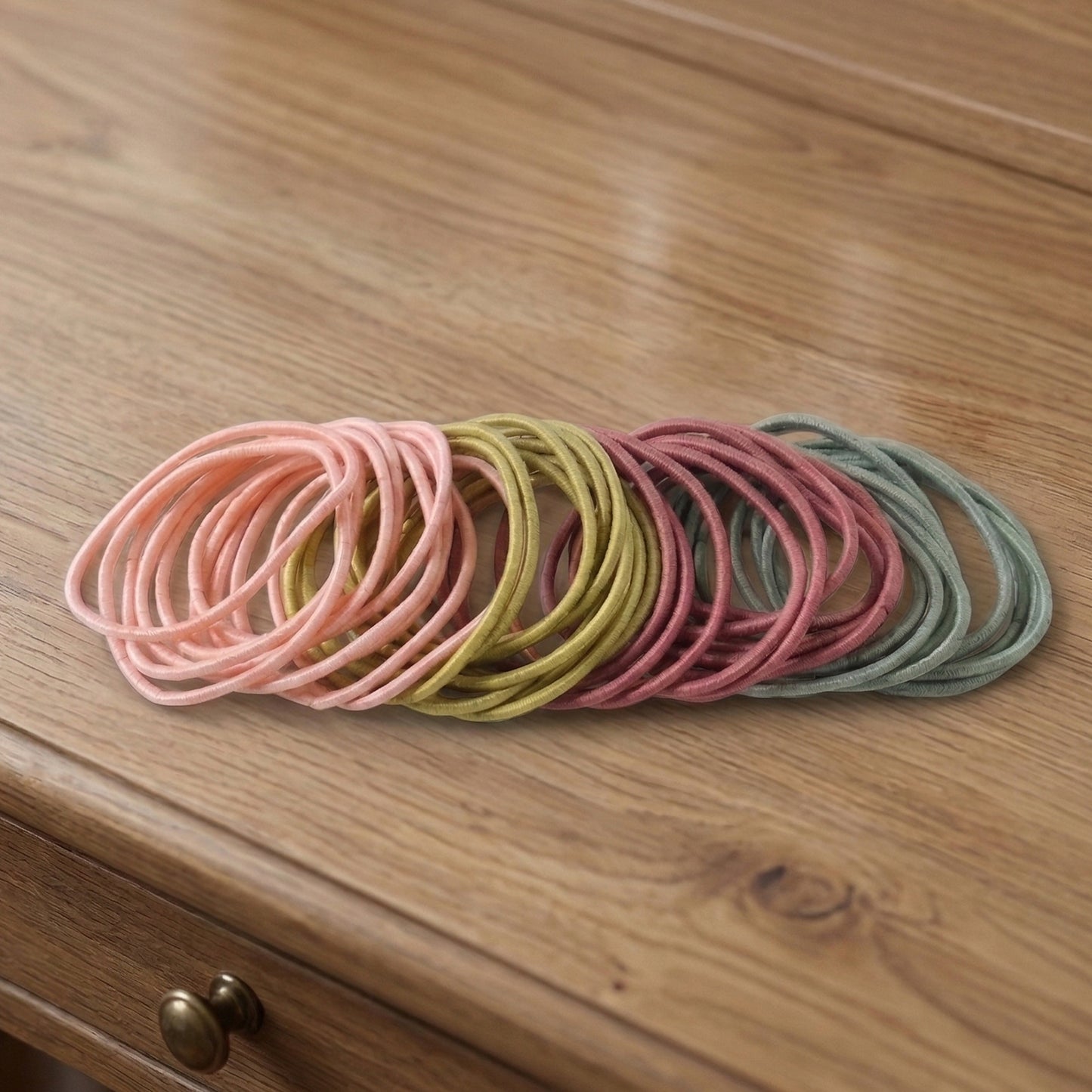 Set of 40 soft stretchable elastic hair bands and rubber hair ties by Wukusy, shown in various colors on a white background.