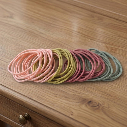Set of 40 soft stretchable elastic hair bands and rubber hair ties by Wukusy, shown in various colors on a white background.