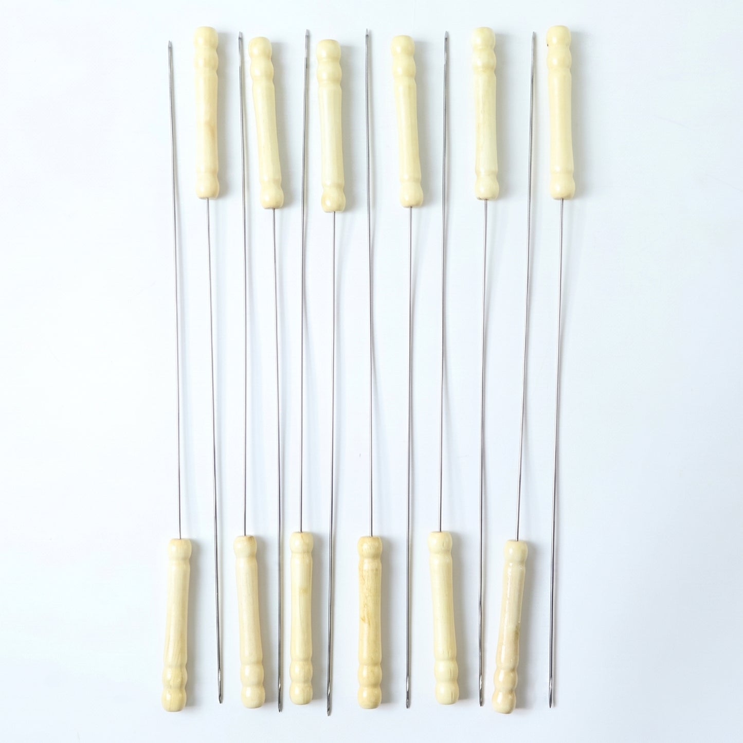 Set of 12 stainless steel BBQ skewers with wooden handles, ideal for grilling kebabs and skewering meats and vegetables.
