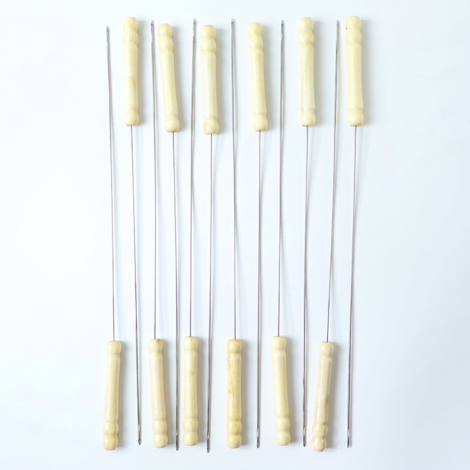 Set of 12 stainless steel BBQ skewers with wooden handles, ideal for grilling kebabs and skewering meats and vegetables.
