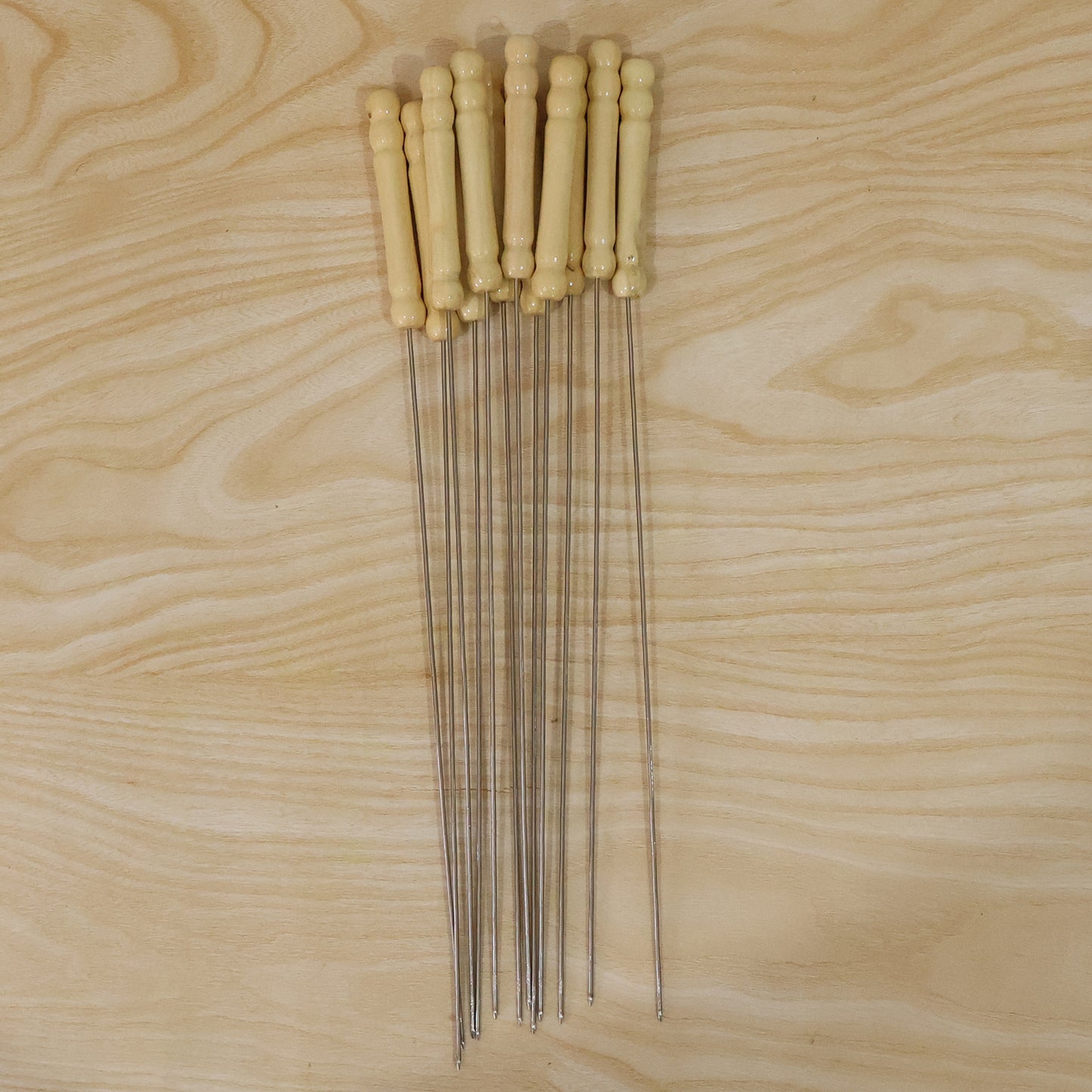 Set of 12 stainless steel BBQ skewers with wooden handles, ideal for grilling and outdoor cooking by Wukusy.