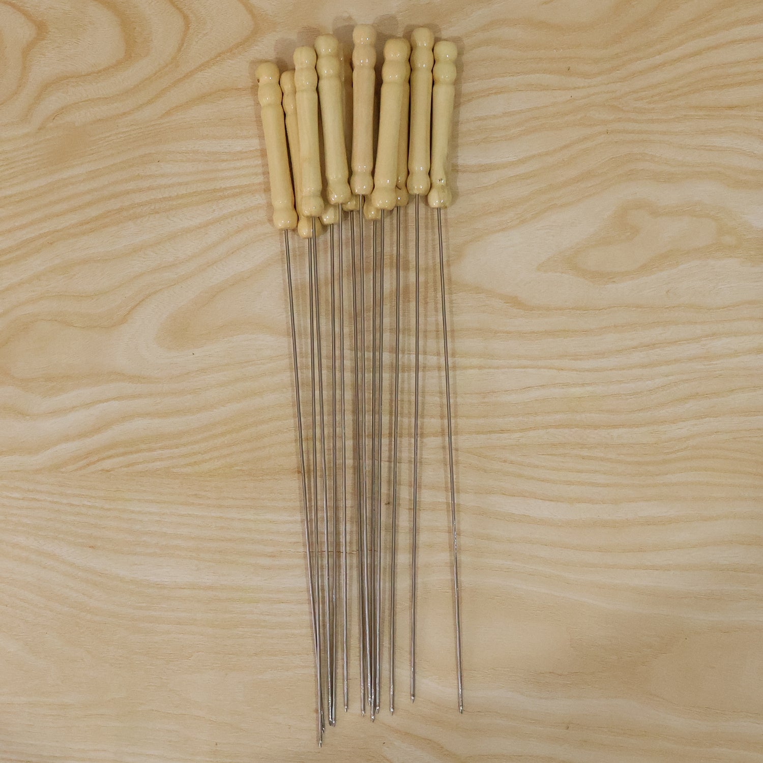 Set of 12 stainless steel BBQ skewers with wooden handles, ideal for grilling and outdoor cooking by Wukusy.