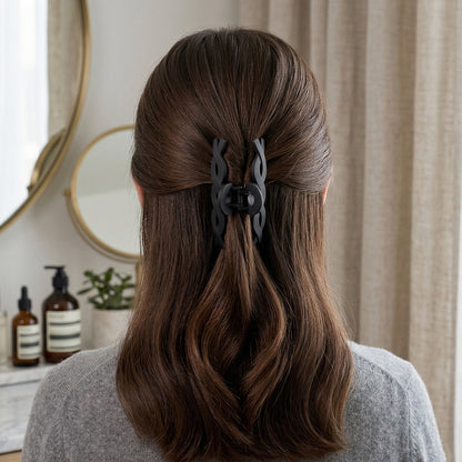Wukusy stylish twist design hair claw clip holding hair, made of durable plastic, in a natural twist pattern.