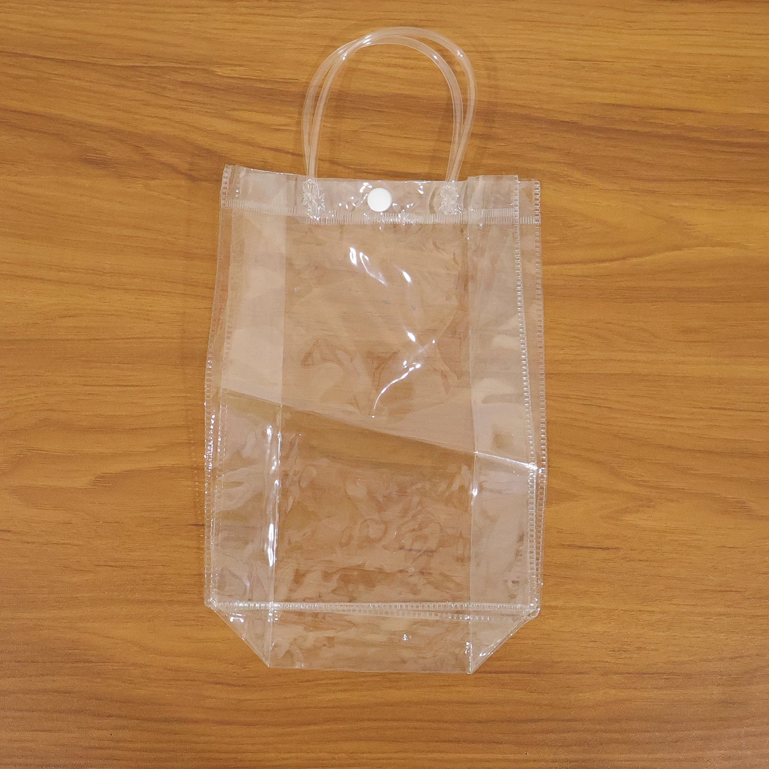 Clear PVC carry bag by Wukusy, 22x16 cm, transparent plastic bag for storage or organization, showing the open bag with handles.