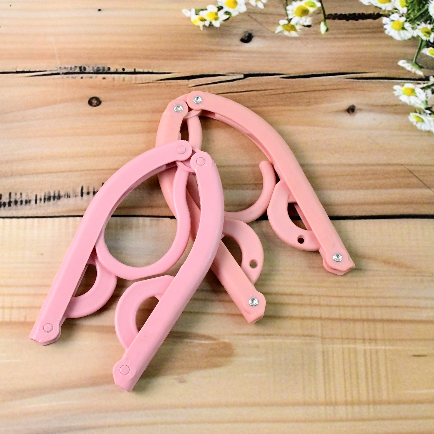 Wukusy portable folding travel clothes hanger, compact and lightweight for easy packing and hanging clothes on the go.