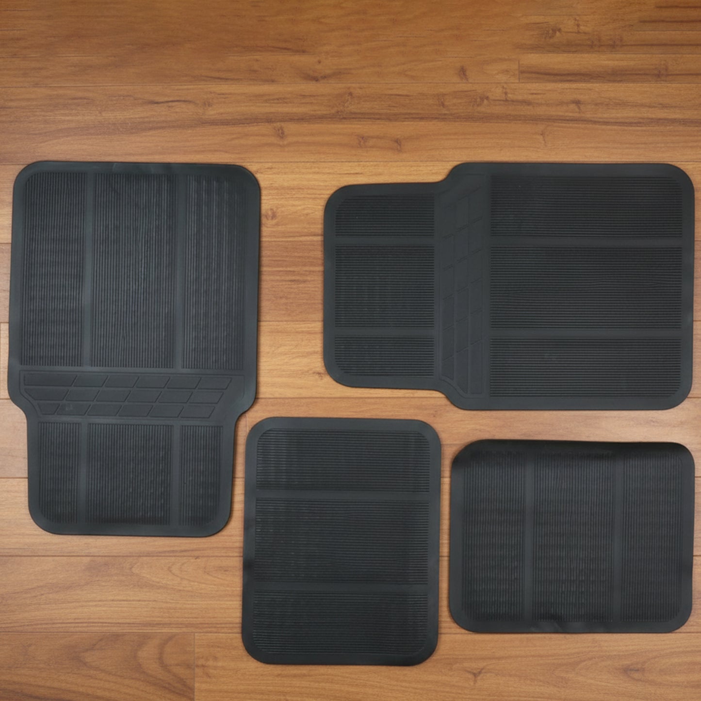 Set of four Wukusy universal car floor mats showing textured rubber surface and edge trimming for vehicle interior protection.