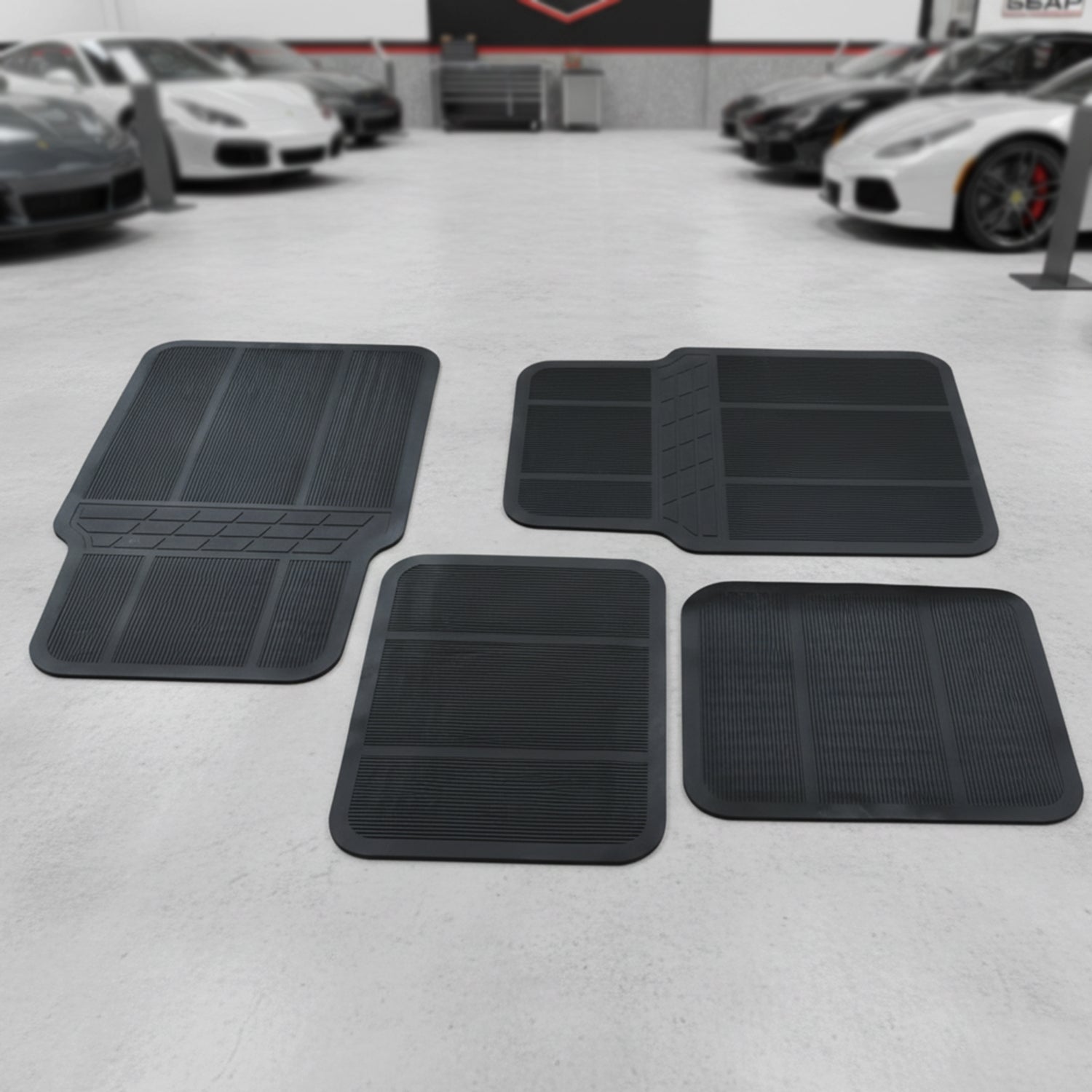 Wukusy universal car floor mat set with four black rubber mats, designed to fit most vehicle interiors.