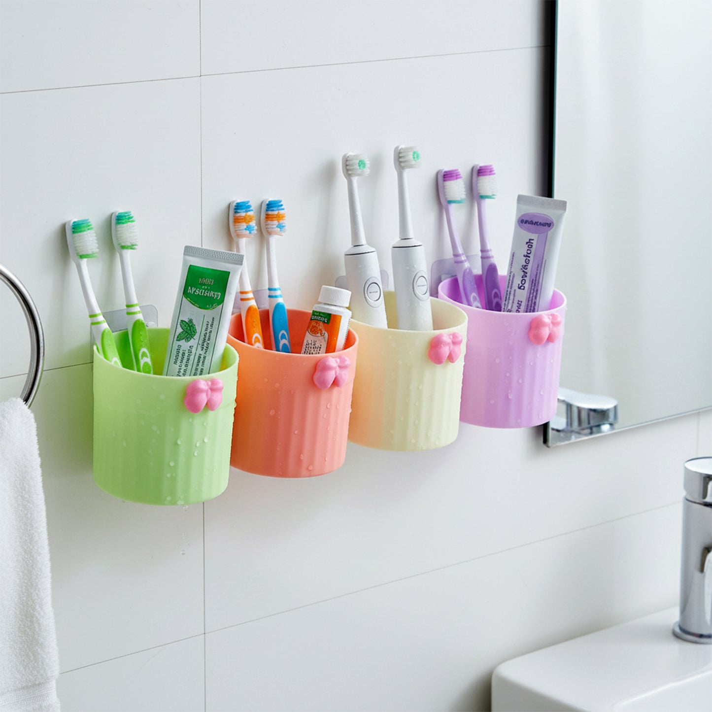 Wall-mounted bathroom toothbrush holder set by Wukusy with four coordinating holders and mounting hardware visible.