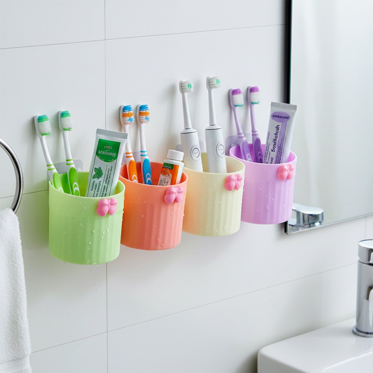 Wall-mounted bathroom toothbrush holder set by Wukusy with four coordinating holders and mounting hardware visible.