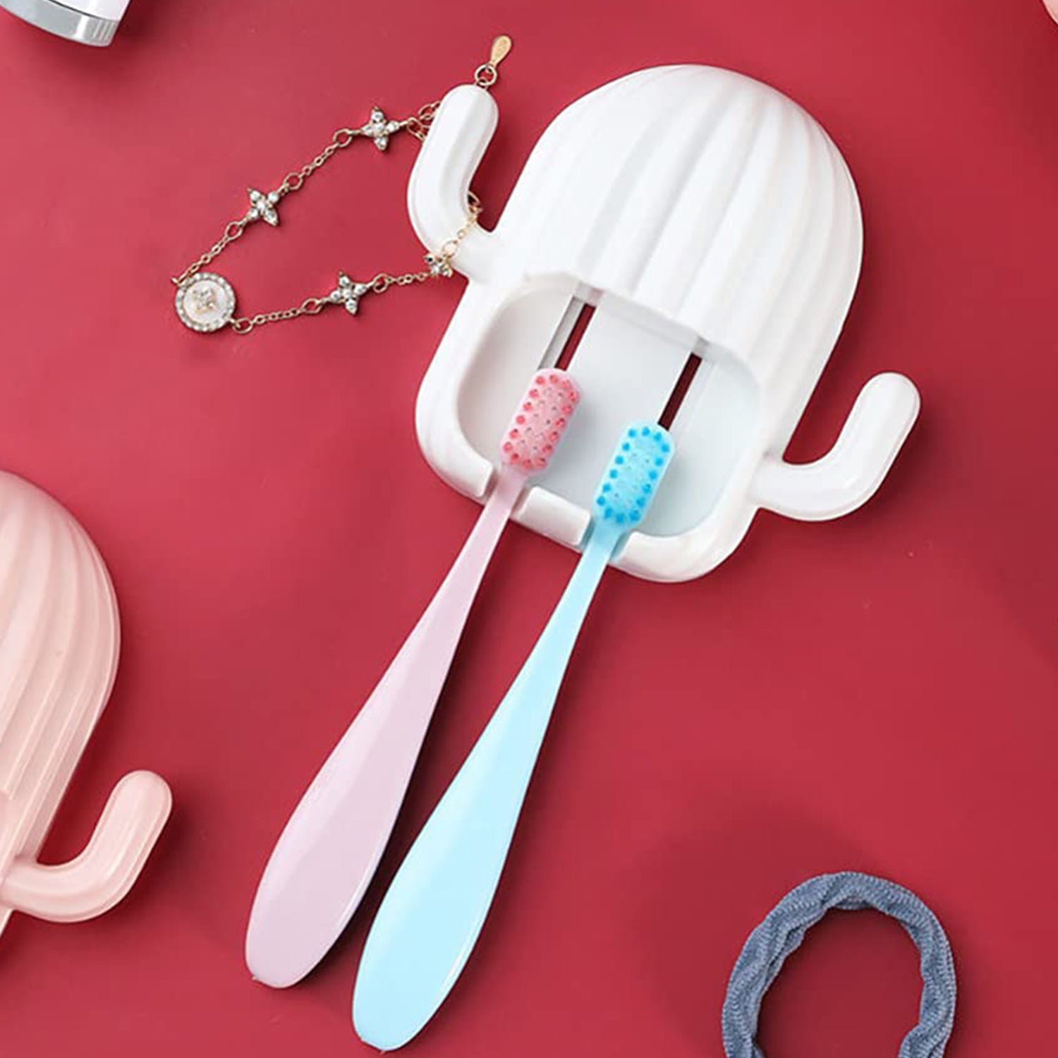 Wall-mounted cactus-shaped toothbrush holder by Wukusy, with space for multiple toothbrushes, mounted on a bathroom wall.