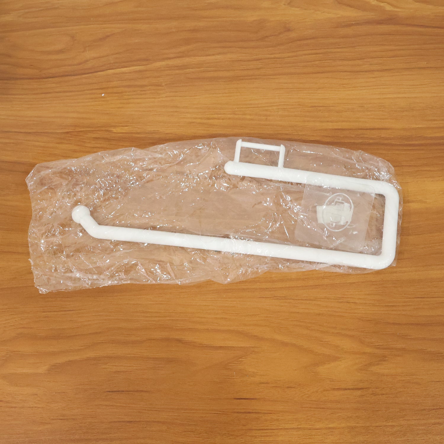 Wall-mounted paper towel holder by Wukusy, featuring a sleek design with a roll of paper towels ready for use.
