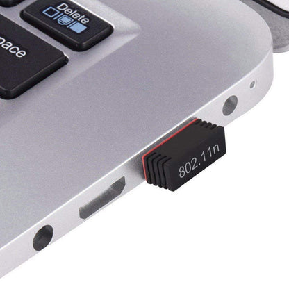 Wukusy 7224 Wi-Fi receiver wireless mini network adapter connected to a laptop, showing USB plug and compact design.