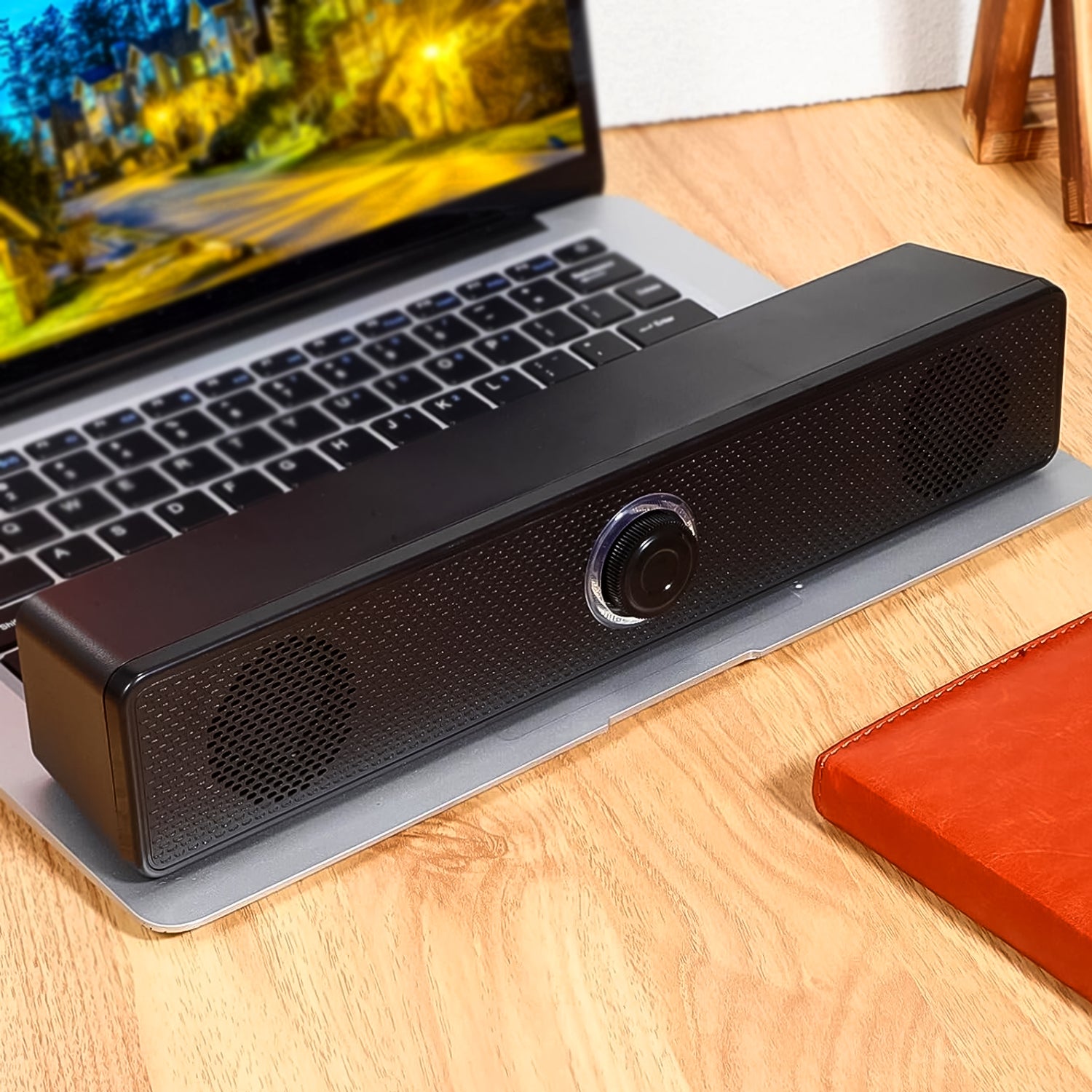 Wukusy wired USB-powered desktop computer speaker with plug-and-play design, compact and black with control buttons.