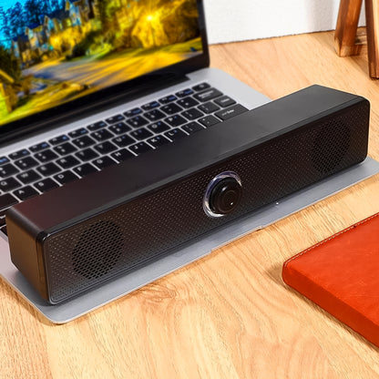 Wukusy wired USB-powered desktop computer speaker with plug-and-play design, compact and black with control buttons.