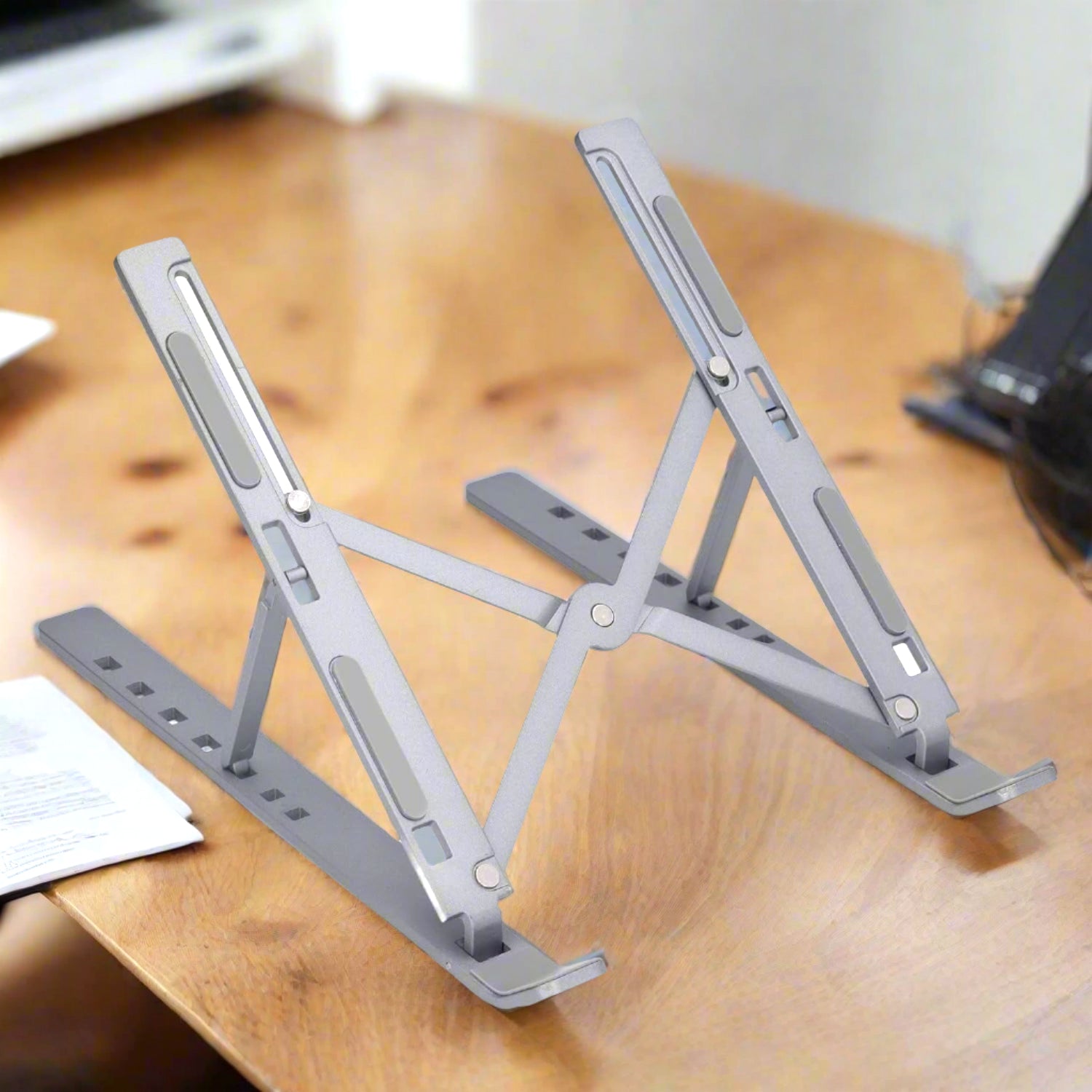 Wukusy metal portable laptop stand with 7 adjustable angles, lightweight and sturdy for ergonomic typing and viewing.