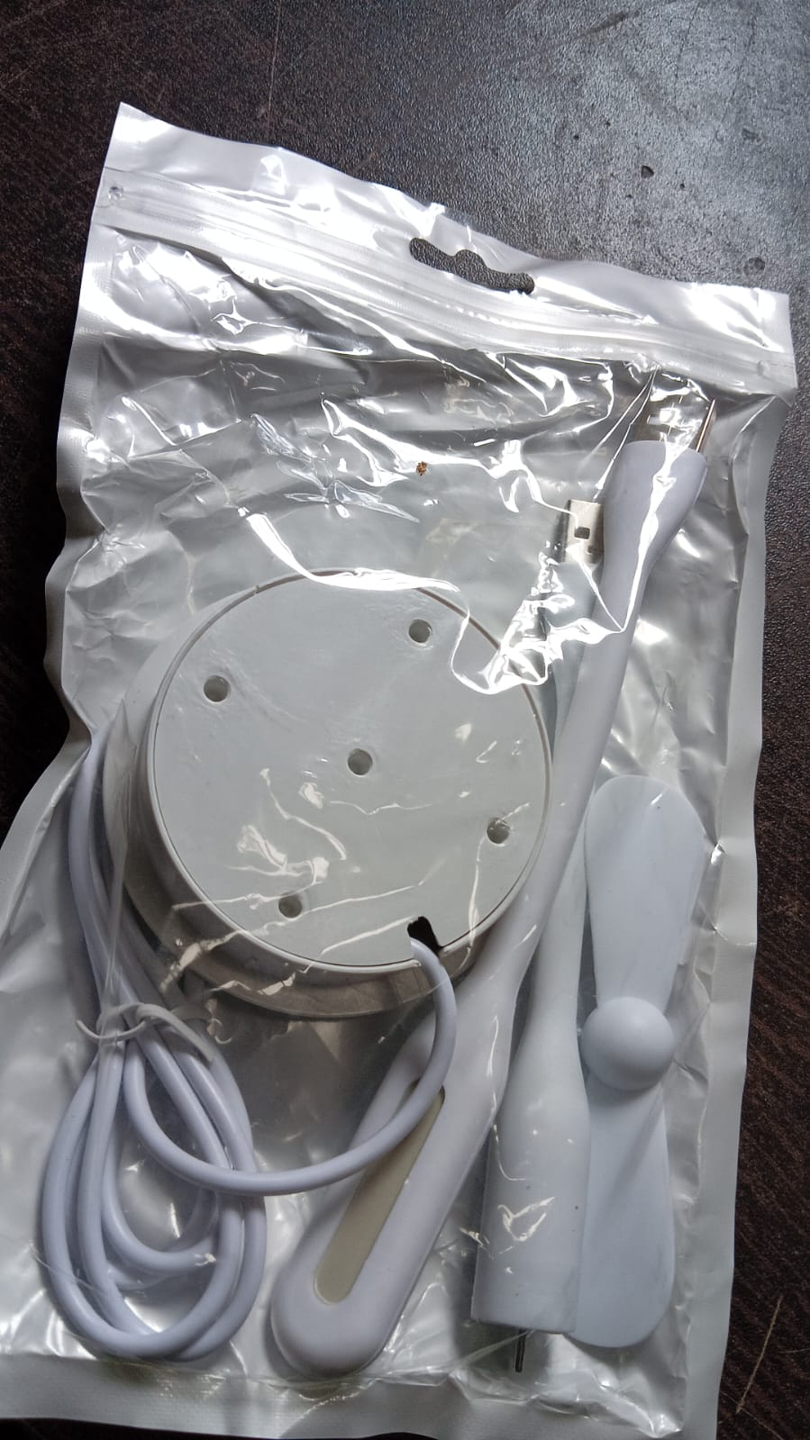 Wukusy portable mini USB fan with built-in USB light and 3-port USB hub, compact electronic device for cooling and connectivity.