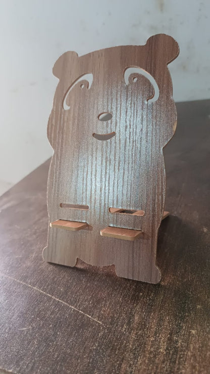 Wooden cartoon shape design mobile stand by Wukusy, perfect for holding smartphones on a flat surface.