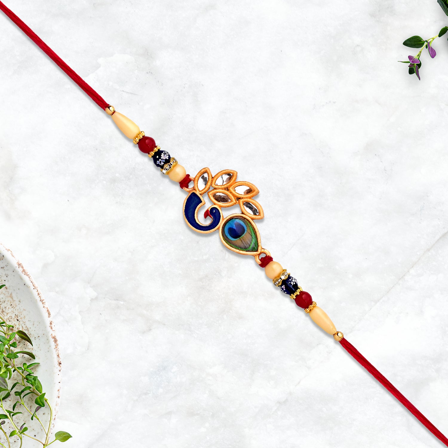 Colorful enamel Artistic Mor Pankh Rakhi with traditional thread, handmade fashion accessory by Wukusy for raksha bandhan celebrations.