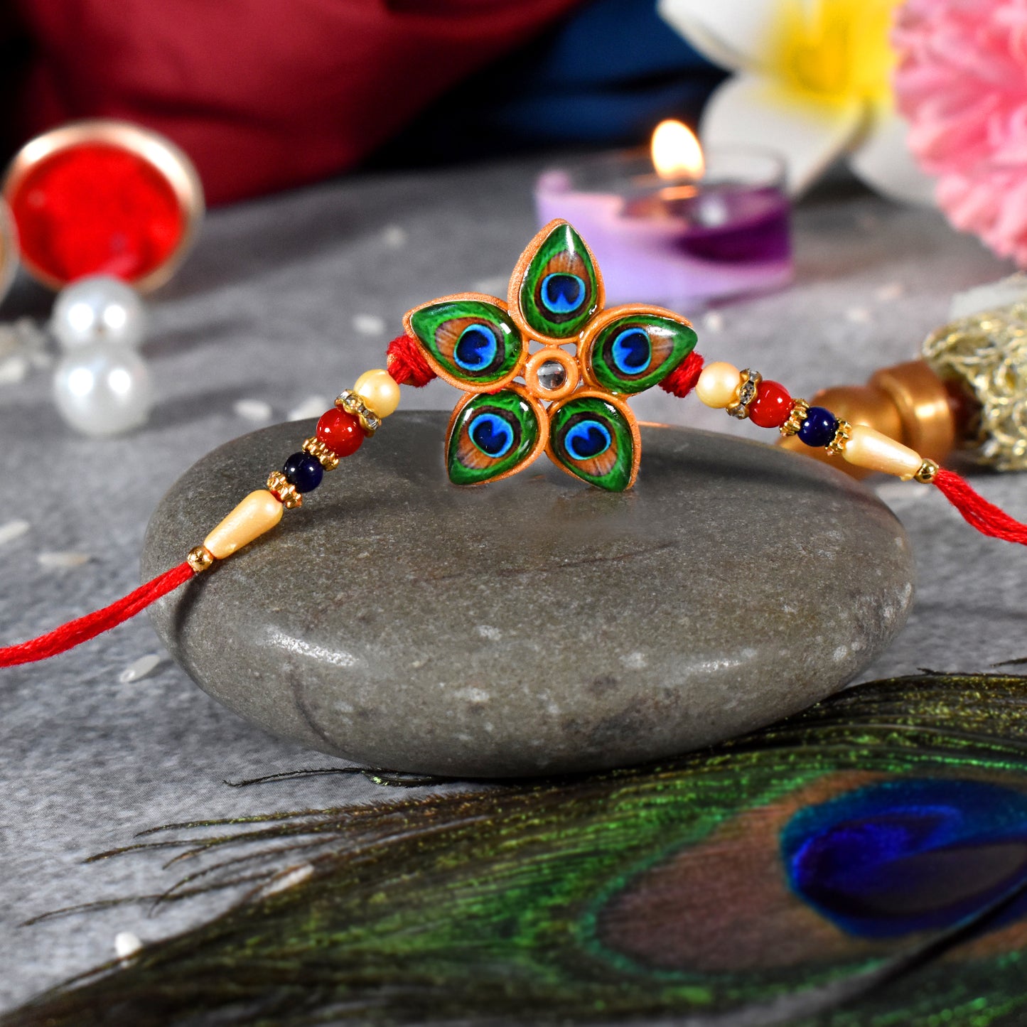 Designer Mor Pankh Rakhi in star shape from Wukusy, featuring intricate fashion jewelry design with colorful feathers and decorative details.