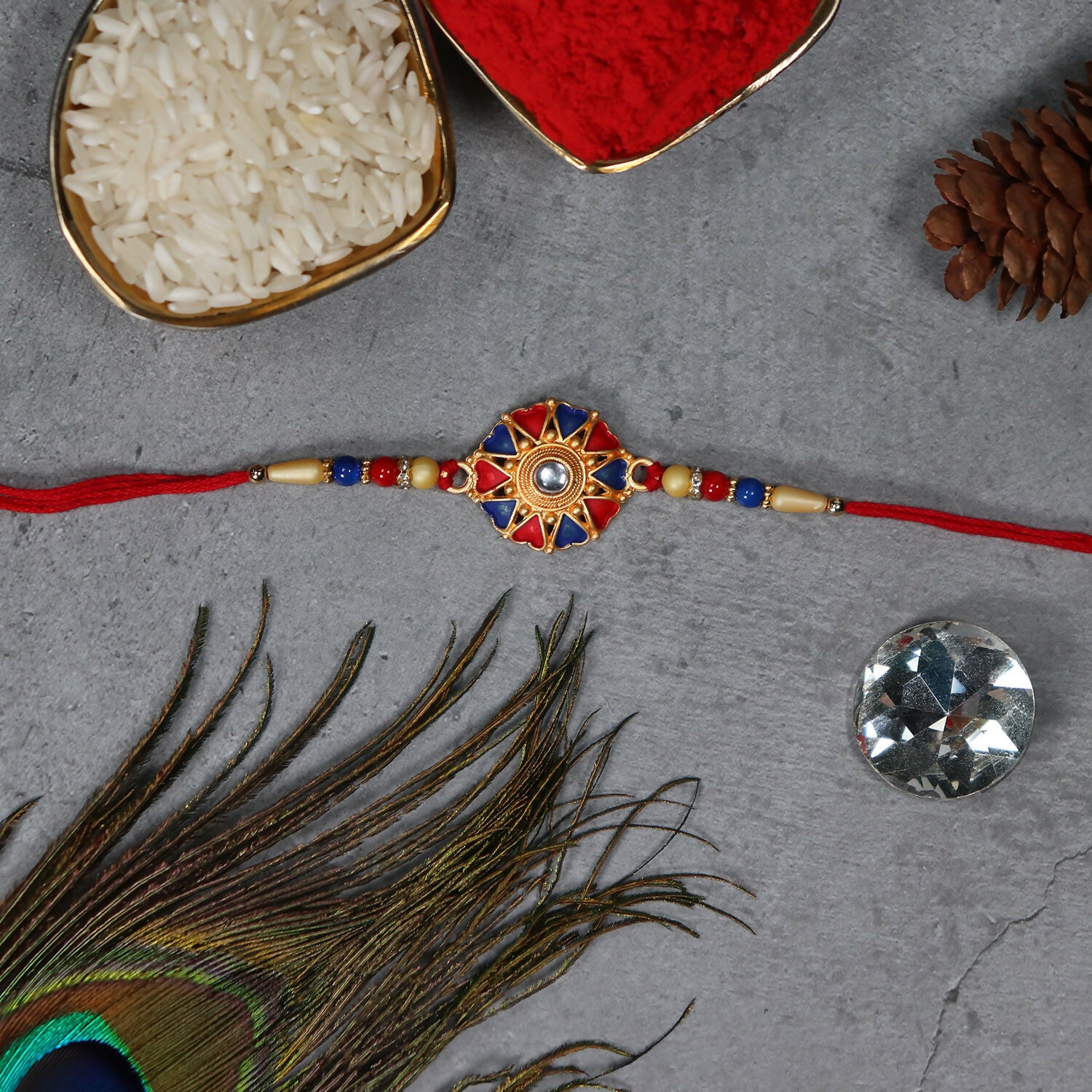 Traditional designer Rakhi from Wukusy showcasing intricate thread work and vibrant colors for festive celebration.