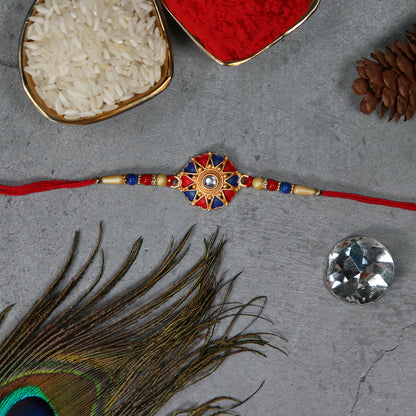 Traditional designer Rakhi from Wukusy showcasing intricate thread work and vibrant colors for festive celebration.